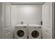 Convenient laundry room features a side-by-side washer and dryer and ample storage at 1486 Joshua Ct, The Villages, FL 32163