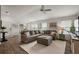 Spacious living room featuring a large sectional sofa, wood floors, and ample natural light at 1486 Joshua Ct, The Villages, FL 32163