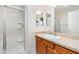 Well-lit bathroom features walk-in shower, vanity with sink, and neutral decor at 1486 Olympia St, The Villages, FL 32163