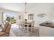 Bright dining room features a stylish table with seating, and sliding glass doors to the backyard at 1486 Olympia St, The Villages, FL 32163