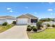 Charming home featuring a well-manicured front yard, a white picket fence, and a one-car garage at 1486 Olympia St, The Villages, FL 32163