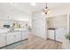 Spacious kitchen with white cabinetry, modern appliances, and a view into the adjoining laundry area at 1486 Olympia St, The Villages, FL 32163