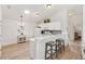 Well-lit kitchen with white cabinetry, a breakfast bar, and stainless steel appliances at 1486 Olympia St, The Villages, FL 32163