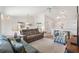 Bright and airy living room featuring comfortable seating, a ceiling fan, and a view of the dining area at 1486 Olympia St, The Villages, FL 32163
