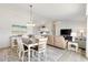 Open-concept living and dining area with hardwood floors and plenty of natural light at 1486 Olympia St, The Villages, FL 32163