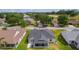 An aerial shot of a well-maintained home with a screened-in lanai and a manicured lawn near a golf course at 17036 Se 79Th Clearview Ave, The Villages, FL 32162