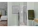 Bright bathroom with a tiled shower and a glimpse into the bedroom; includes an updated showerhead at 17036 Se 79Th Clearview Ave, The Villages, FL 32162