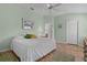 Cozy bedroom with hardwood floors, a ceiling fan, and ample natural light, creating a warm and inviting atmosphere at 17036 Se 79Th Clearview Ave, The Villages, FL 32162