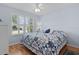 Charming bedroom with hardwood floors, a ceiling fan, and a bed with a quilt at 17036 Se 79Th Clearview Ave, The Villages, FL 32162