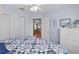 Inviting bedroom with hardwood floors, large windows, and a view into other rooms, enhancing the open feel at 17036 Se 79Th Clearview Ave, The Villages, FL 32162