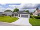 Inviting single-story home with a manicured lawn, a two-car garage, and lovely landscaping at 17036 Se 79Th Clearview Ave, The Villages, FL 32162