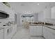 Charming kitchen with white cabinets, modern appliances, and a delightful breakfast area at 17036 Se 79Th Clearview Ave, The Villages, FL 32162