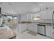 Bright kitchen featuring white cabinets, stylish countertops, and a cozy breakfast nook at 17036 Se 79Th Clearview Ave, The Villages, FL 32162