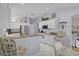 Well-lit kitchen with white cabinets, stainless steel appliances, and a convenient breakfast bar at 17036 Se 79Th Clearview Ave, The Villages, FL 32162