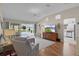 Cozy living room featuring ample seating, a ceiling fan, and access to the screened outdoor area at 17036 Se 79Th Clearview Ave, The Villages, FL 32162