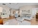 Inviting living room with stylish decor, wood floors, and a comfortable seating arrangement at 17036 Se 79Th Clearview Ave, The Villages, FL 32162