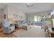 Bright living room boasts wood floors and neutral walls, creating an inviting and airy atmosphere at 17036 Se 79Th Clearview Ave, The Villages, FL 32162