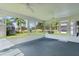 Bright sunroom with ceiling fans and screened windows overlooking lush landscaping and a golf course at 17036 Se 79Th Clearview Ave, The Villages, FL 32162