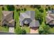 Stunning aerial view of a well-maintained home with a lush green yard and beautiful landscaping at 1721 Sunset Ridge Dr, The Villages, FL 32162