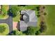 Aerial of a house with a gray roof in a beautiful residential neighborhood at 1721 Sunset Ridge Dr, The Villages, FL 32162