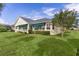 Charming backyard features a sunroom and mature landscaping for added privacy and appeal at 1721 Sunset Ridge Dr, The Villages, FL 32162