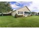 The home boasts a sunroom and lush landscaping for added backyard privacy and appeal at 1721 Sunset Ridge Dr, The Villages, FL 32162