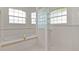 Bright bathroom features glass block wall, tiled tub, and separate shower at 1721 Sunset Ridge Dr, The Villages, FL 32162