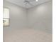 A well-lit, empty bedroom with tiled floors, ceiling fan and a window at 1721 Sunset Ridge Dr, The Villages, FL 32162