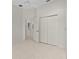 The bedroom features a fan, tile flooring, and double-door closets at 1721 Sunset Ridge Dr, The Villages, FL 32162