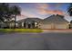 Lovely single-story home boasts a three-car garage, lush lawn, and well-maintained landscaping at 1721 Sunset Ridge Dr, The Villages, FL 32162