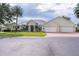 Lovely single-story home boasts a three-car garage, lush lawn, and well-maintained landscaping at 1721 Sunset Ridge Dr, The Villages, FL 32162