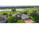Desirable home with a two-car garage, manicured lawn, and brick paved driveway overlooking the golf course and lake at 1721 Sunset Ridge Dr, The Villages, FL 32162