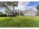 Well-kept lawn and shrubbery complement this beautiful single-story home with a three-car garage at 1721 Sunset Ridge Dr, The Villages, FL 32162