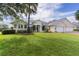 Well-kept lawn and shrubbery complement this beautiful single-story home with a three-car garage at 1721 Sunset Ridge Dr, The Villages, FL 32162
