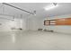 Spacious garage with epoxy flooring, ample storage, and room for multiple vehicles at 1721 Sunset Ridge Dr, The Villages, FL 32162