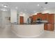 Kitchen with granite countertops, tile floors, wood cabinets, island and stainless steel appliances at 1721 Sunset Ridge Dr, The Villages, FL 32162