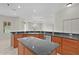 Spacious kitchen with wood cabinets, granite counters, island and stainless steel appliances at 1721 Sunset Ridge Dr, The Villages, FL 32162