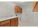 Practical laundry area with a sink, lots of storage, and a door for easy access to the outside at 1721 Sunset Ridge Dr, The Villages, FL 32162