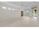 Bright, open living room with tile flooring, large windows, and access to the outdoor patio at 1721 Sunset Ridge Dr, The Villages, FL 32162