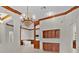 Elegant dining and living space featuring a crystal chandelier, archway, and built in wine storage at 1721 Sunset Ridge Dr, The Villages, FL 32162