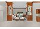 Bright living room with stylish built-ins, white tile floors, and comfortable seating at 1721 Sunset Ridge Dr, The Villages, FL 32162