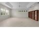 Open living room with tile floors, tray ceiling with fan and many windows at 1721 Sunset Ridge Dr, The Villages, FL 32162