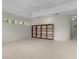 Open living room with tile floors, tray ceilings and a large wooden bookcase at 1721 Sunset Ridge Dr, The Villages, FL 32162