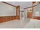 Open-concept living room with hardwood floors, wood trim, and stylish built-in shelving at 1721 Sunset Ridge Dr, The Villages, FL 32162