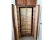 Wooden pantry with shelves in the kitchen offers plenty of storage space at 1721 Sunset Ridge Dr, The Villages, FL 32162