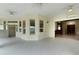 Spacious patio with tiled floor, ceiling fans, and multiple access points to the home's interior at 1721 Sunset Ridge Dr, The Villages, FL 32162