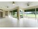 Bright and airy patio with large windows providing panoramic views of the surrounding greenery and golf course at 1721 Sunset Ridge Dr, The Villages, FL 32162