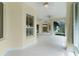 Large, sunlit patio featuring tiled flooring, multiple ceiling fans, and expansive windows offering serene views at 1721 Sunset Ridge Dr, The Villages, FL 32162