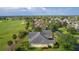 Back of a charming house in an attractive residential neighborhood, bordering a golf course at 1721 Sunset Ridge Dr, The Villages, FL 32162