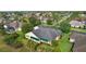 Back of a pleasant home in a lovely residential area with lush landscaping and manicured lawns at 1721 Sunset Ridge Dr, The Villages, FL 32162